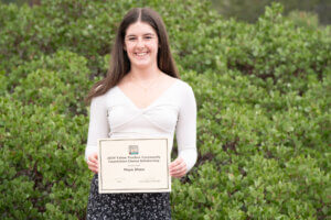 High school scholarship recipient posing with award certificate